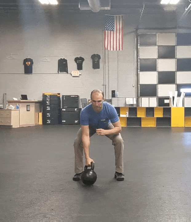 Coach Ryan demonstrates a kettlebell clean and jerk.