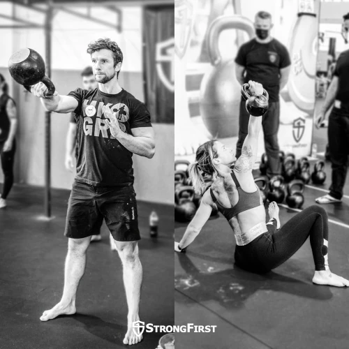 A man does kettlebell one-hand swings while a woman does a kettlebell get-up.