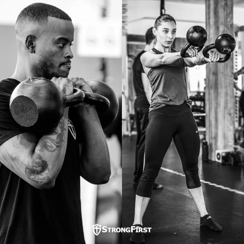 A man racks a pair of kettlebells while a woman does double kettlebell swings.