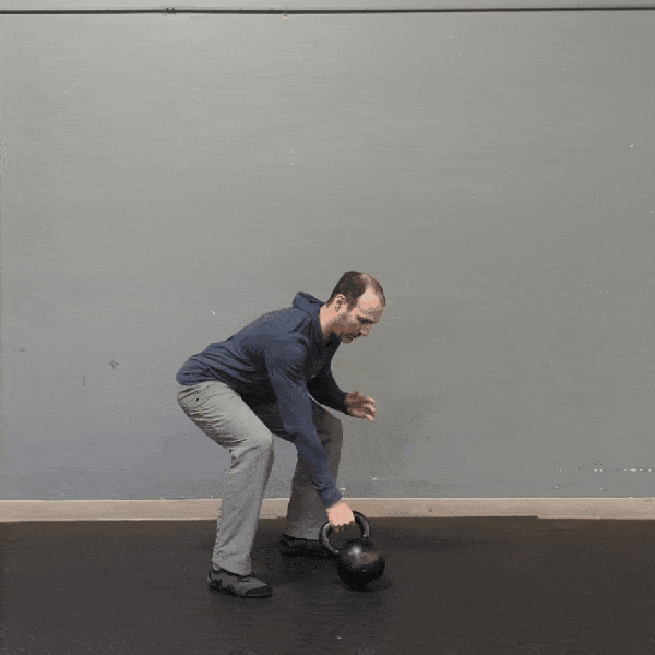 Coach Ryan demonstrates packed shoulders while doing swings.